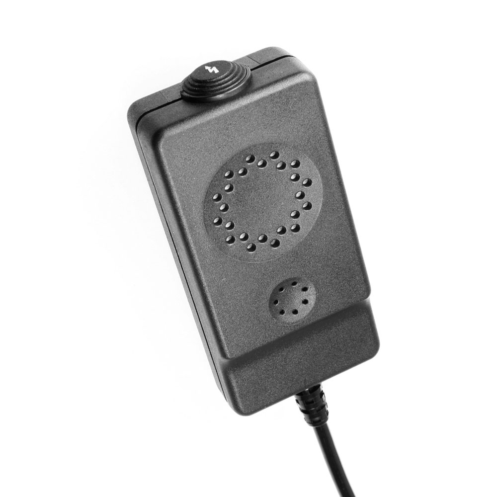 Black rectangular device with button and cable, features circular speaker grilles.