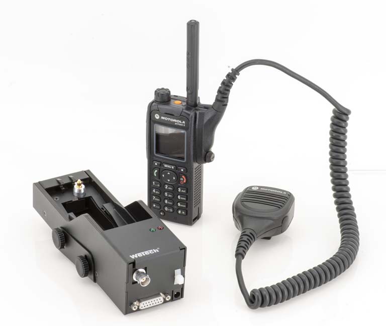 Radio with microphone and charger on a light background.