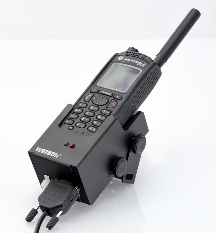 A radio on a docking station with visible connectors and control lights.