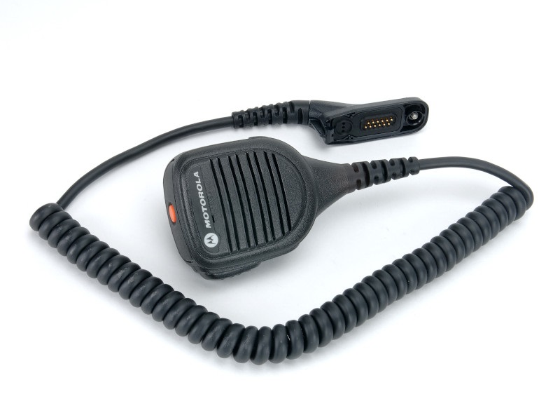 Handheld microphone with coiled cable and connector.
