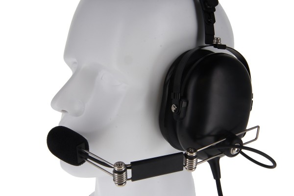 Mannequin head wearing black headphones with microphone.