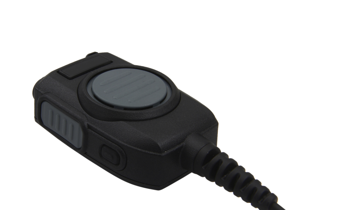 Black microphone with push-to-talk button and coiled cable.