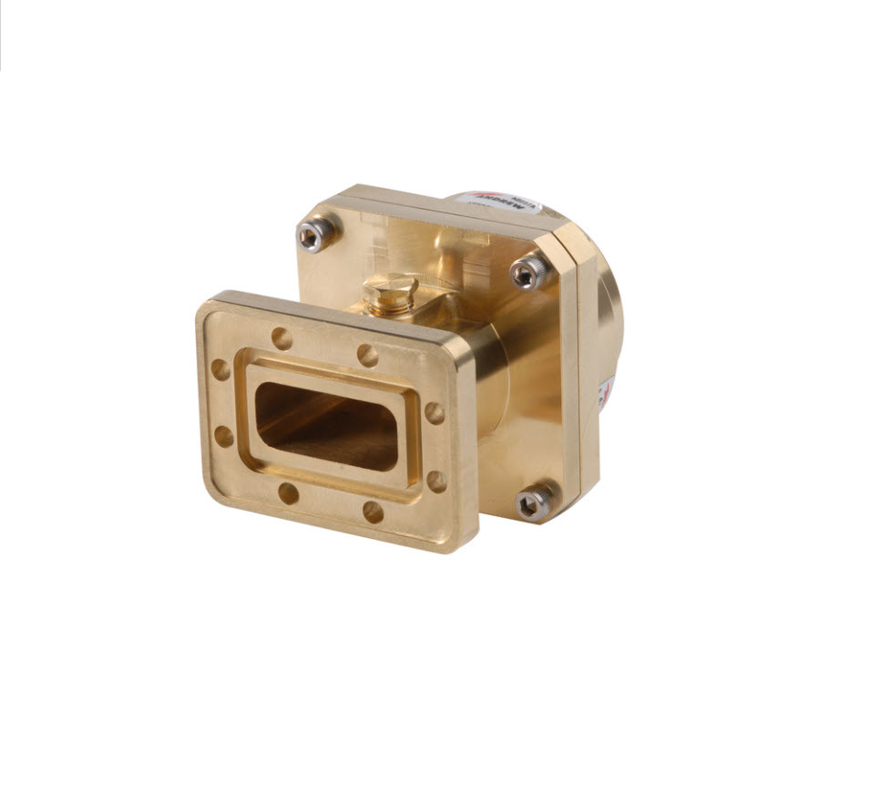Rectangular, gold-colored metal circuit with bolts at the corners.