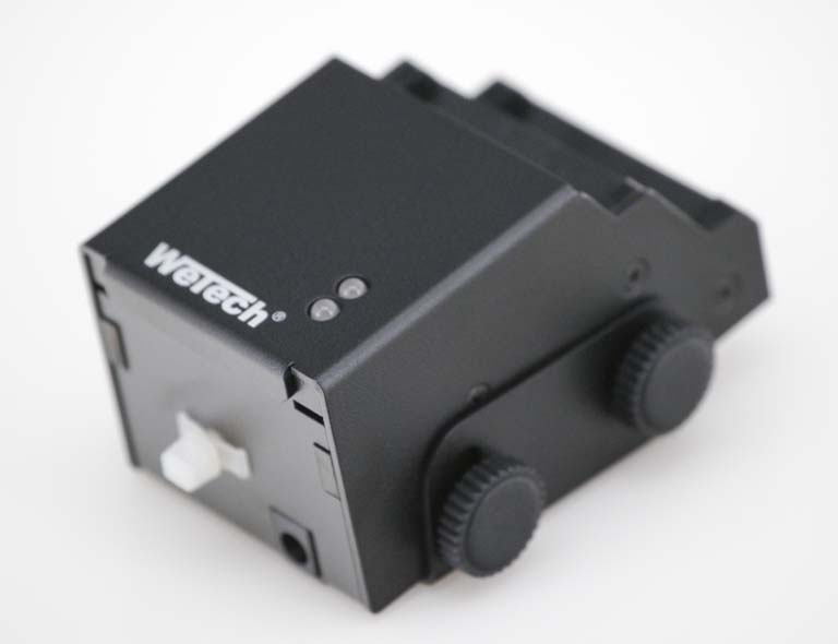 Black electronic device with two dials and white switches.