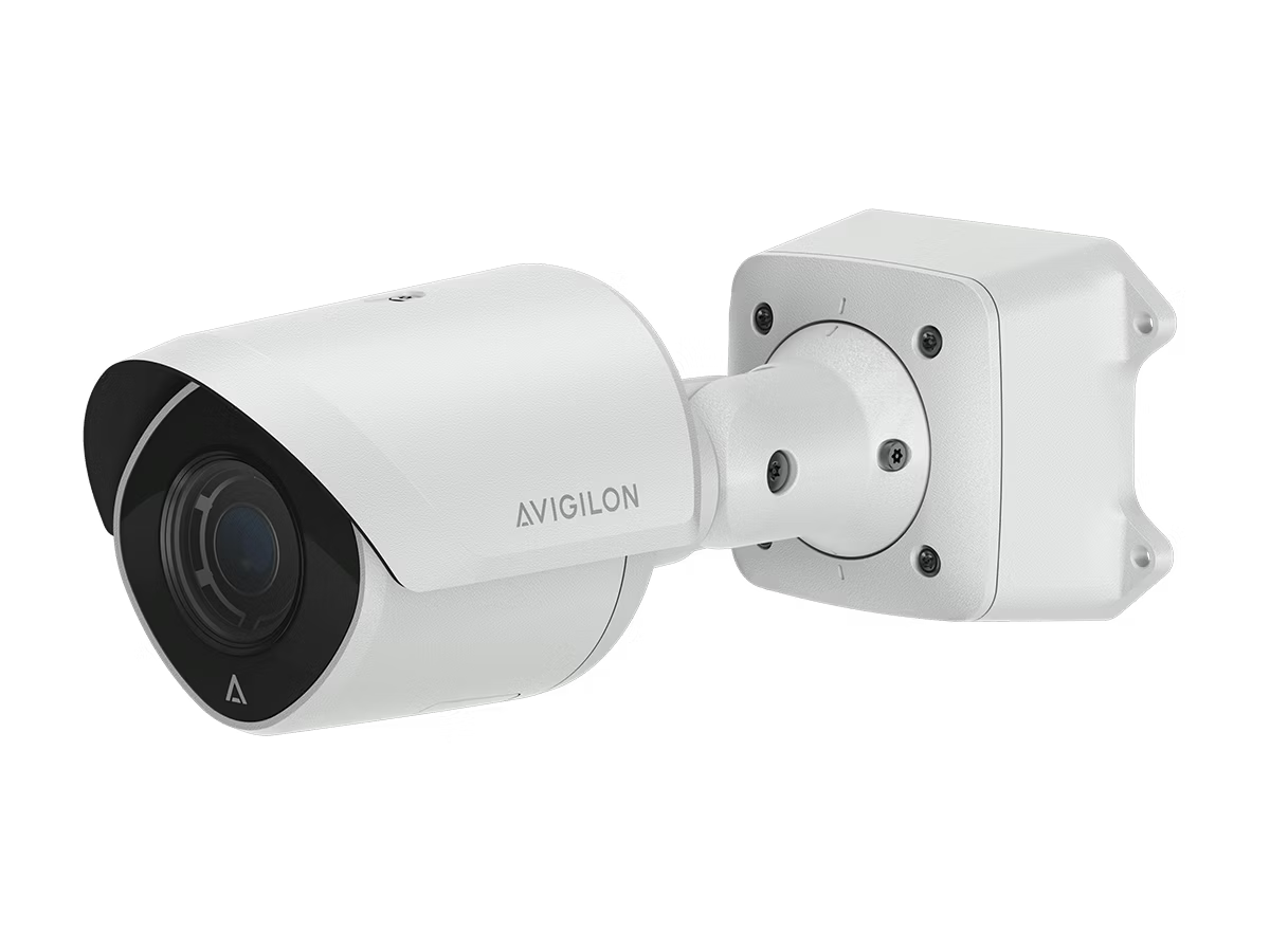 White surveillance camera with wall mount.