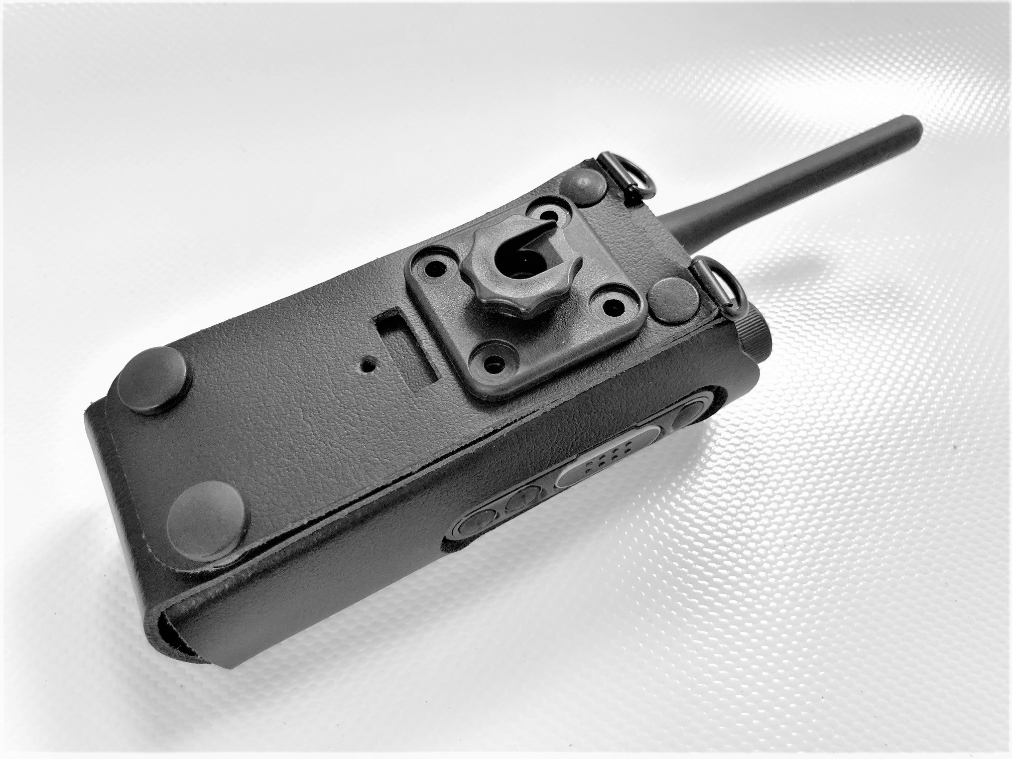 Black radio device in protective case on white background.