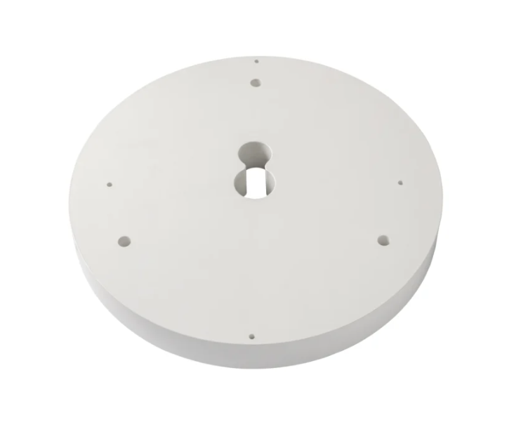 Round white mounting accessory with multiple screw holes.