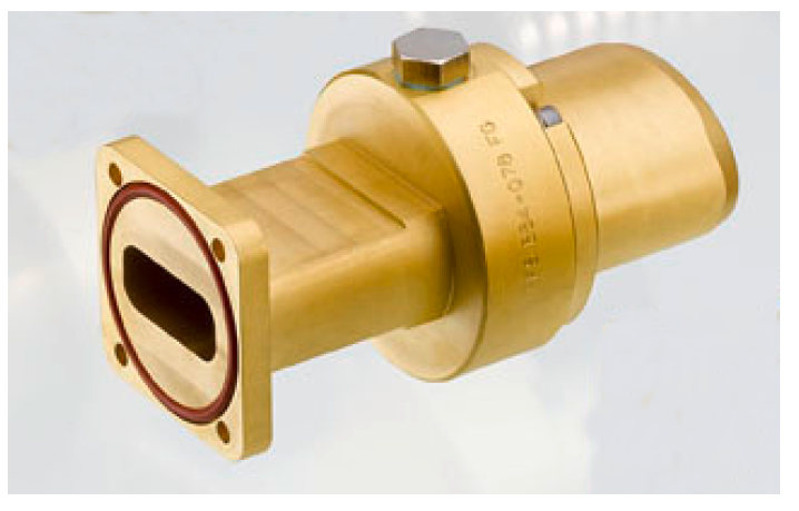 Rectangular brass adapter with nut on top on light background.