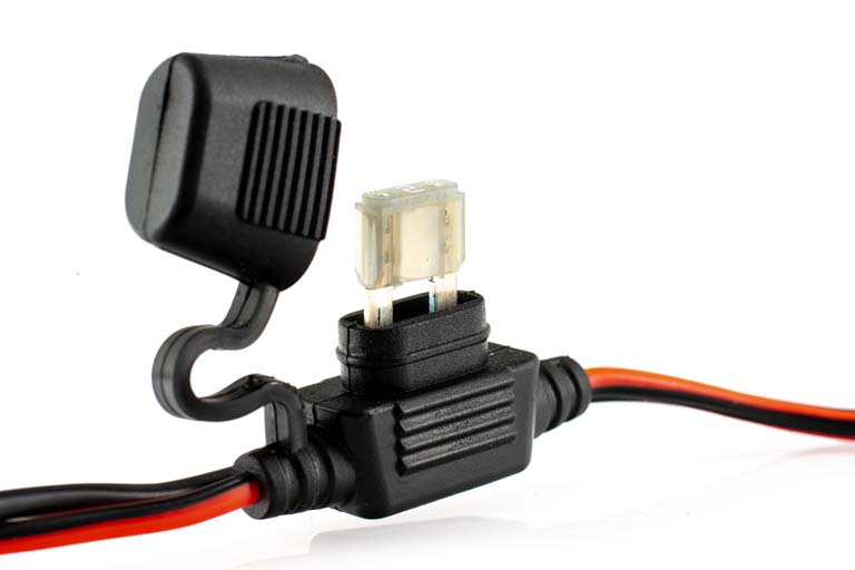 Car fuse holder with open cover and installed blade fuse.