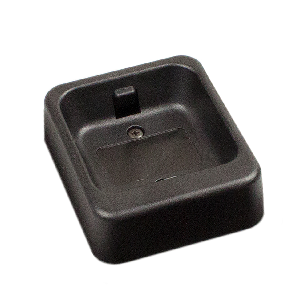 Black charging base with rectangular recess and metal contact.