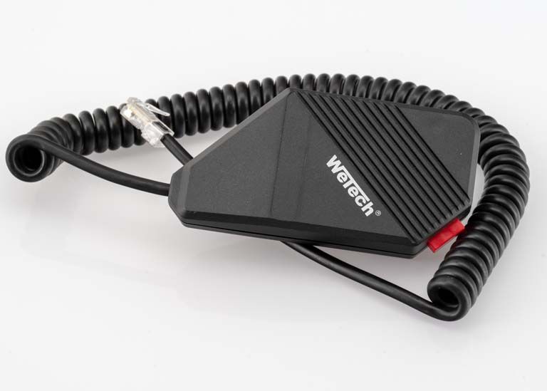 Black handheld microphone with coiled connection cable and logo on the front.