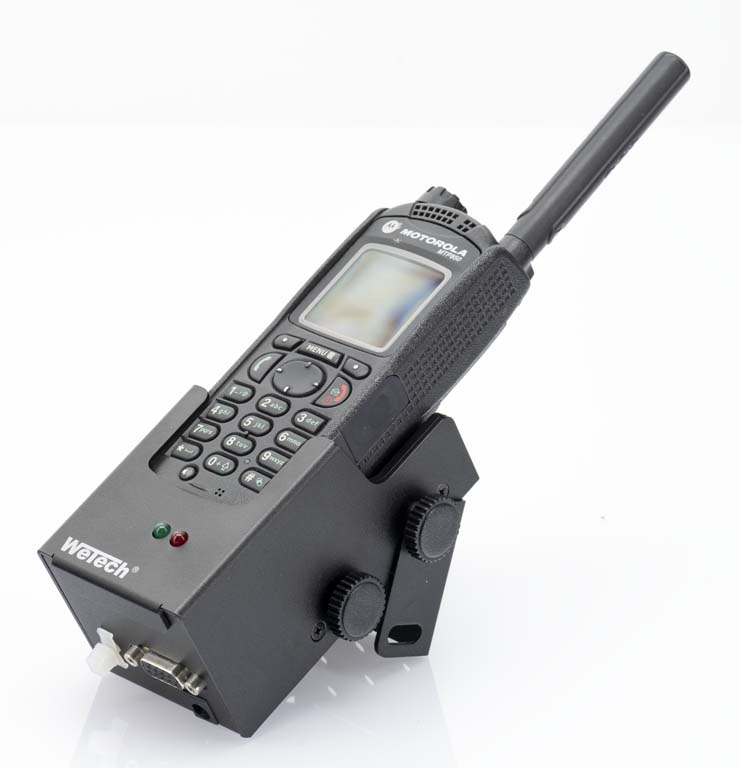 Two-way radio in a charging station with antenna and keypad.