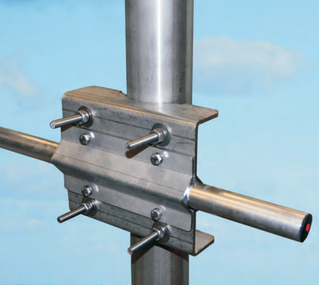 Metal joint with bolts on a pipe against a blue background.