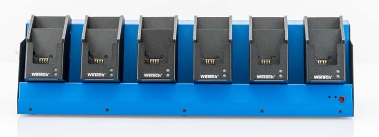 7000_00754029_WEM_01.jpg Six-bay charger with blue base and black holders on top.