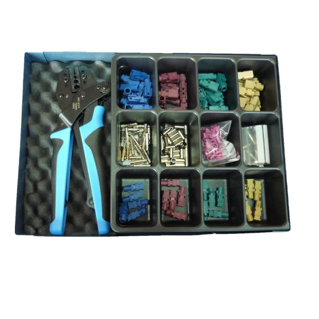 Toolbox with crimping pliers and various colored connectors in compartments.