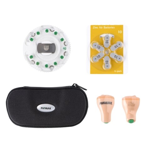 Hearing aid accessory set with batteries, case, and two earpieces.