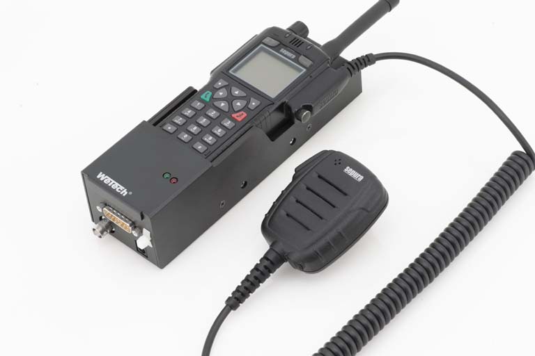 Funkgerät mit Mikrofon, Kabel angeschlossen, auf weißem Hintergrund.