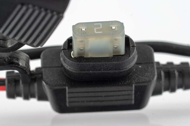 Close-up of a fuse in a holder, number 2 visible.