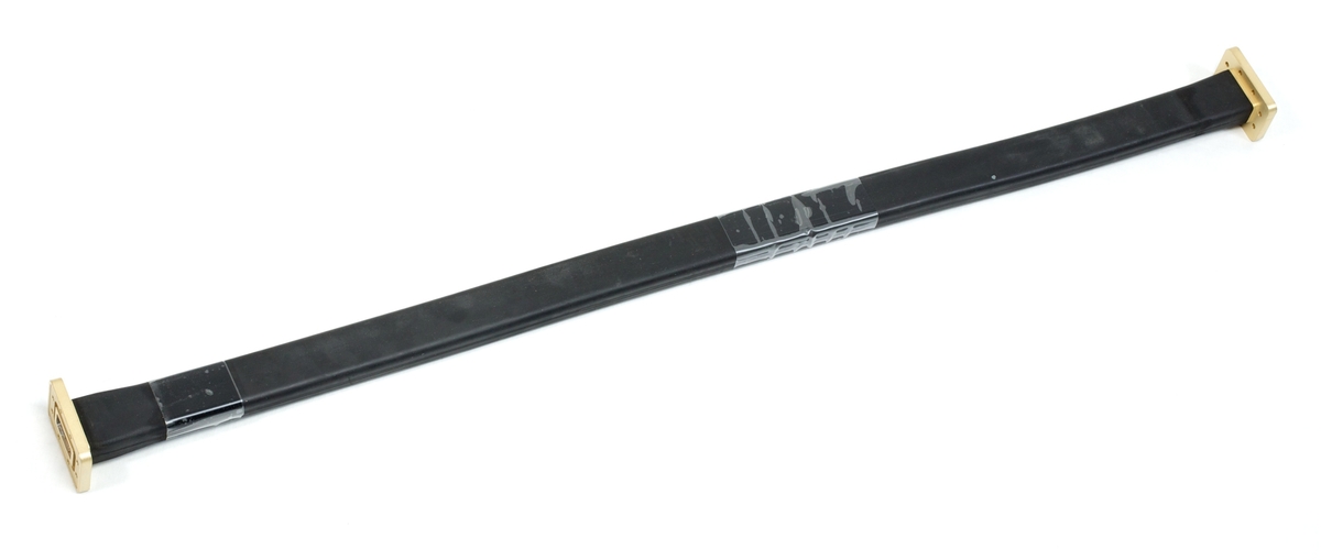 7000-00753421_com_02.jpg Black plastic strip with two rectangular, gold-colored ends.