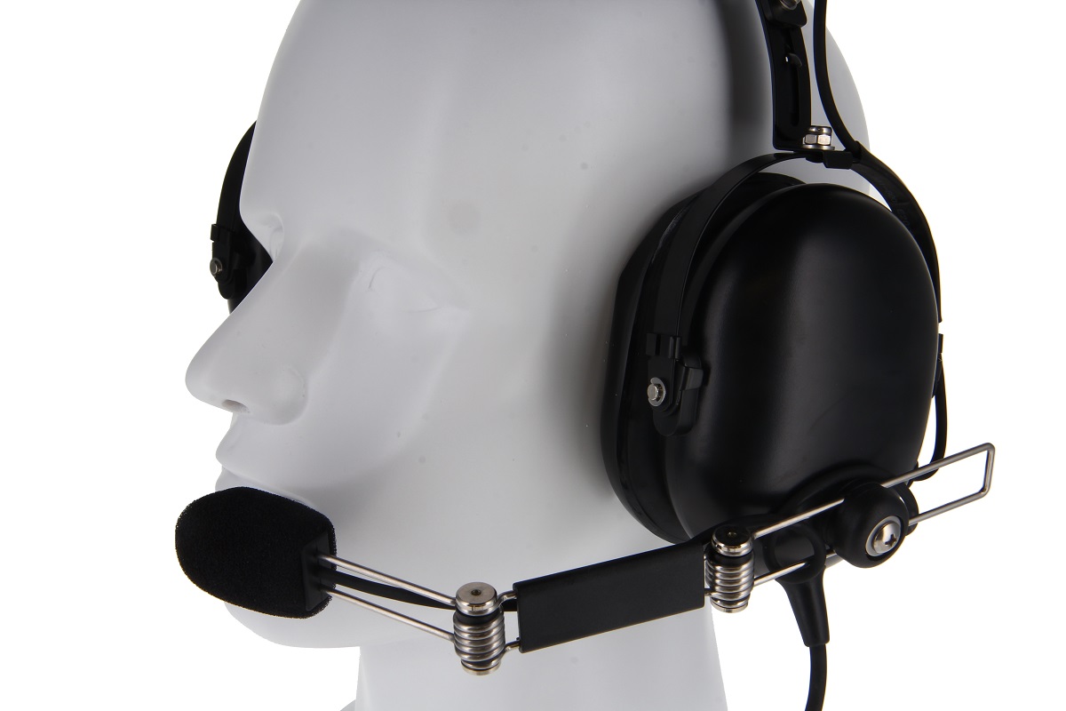 Mannequin wearing black headphones with microphone.