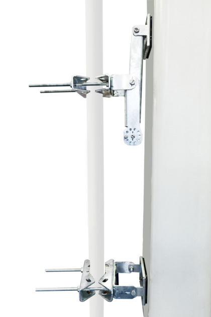 Two metal clamps on a vertical white panel.