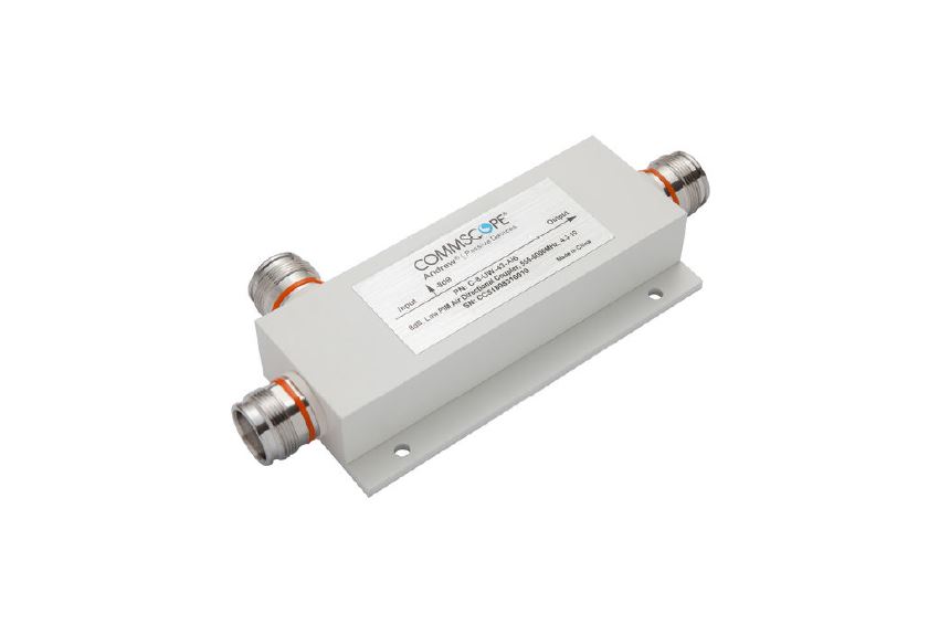 7000-00038700_com_01.jpg White RF power divider with two connectors and label on top.