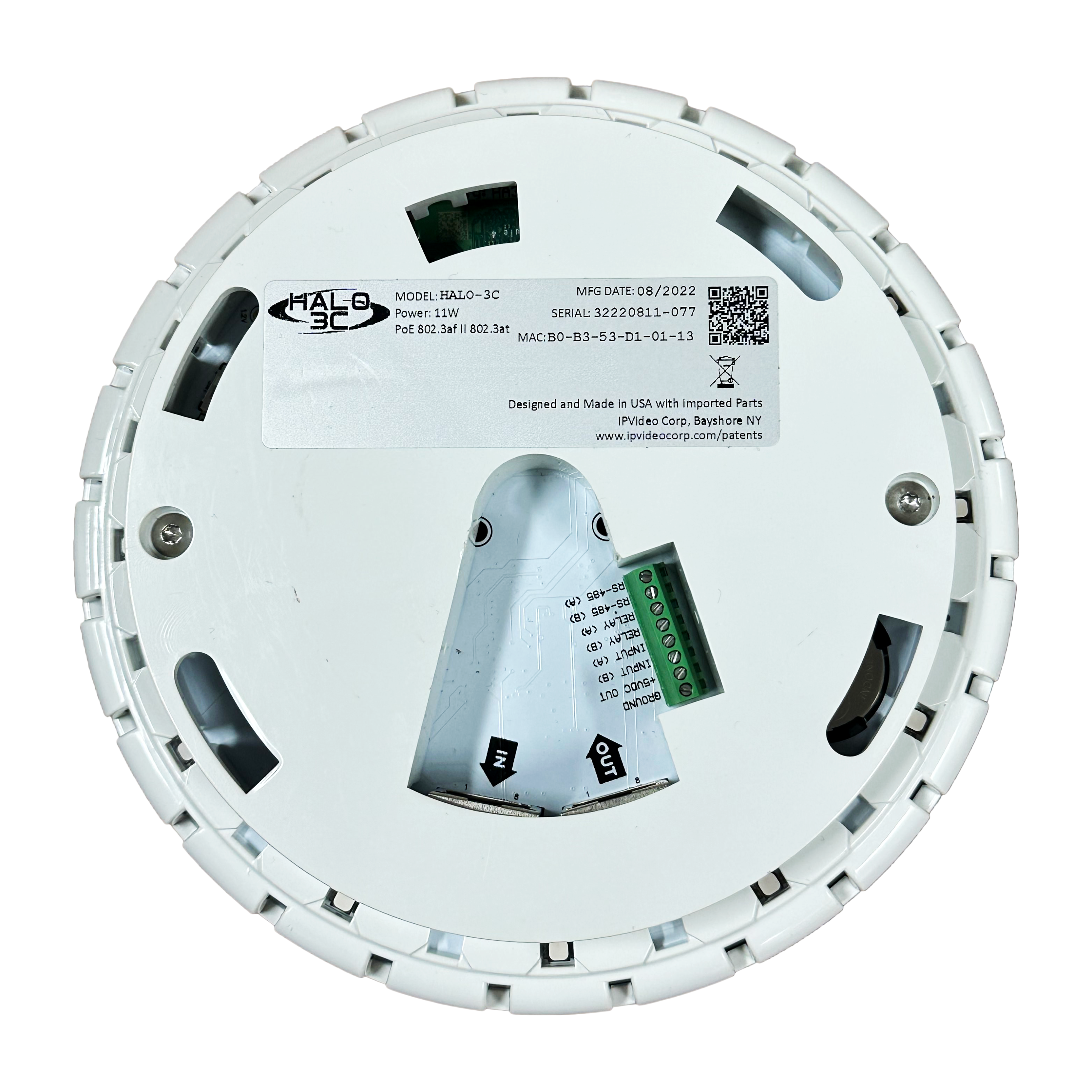 Unterseite eines runden Elektronikgeräts mit Aufkleber und Anschlüssen.