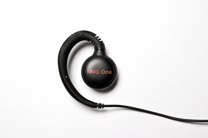 A black earpiece with a cable and Mag One logo.