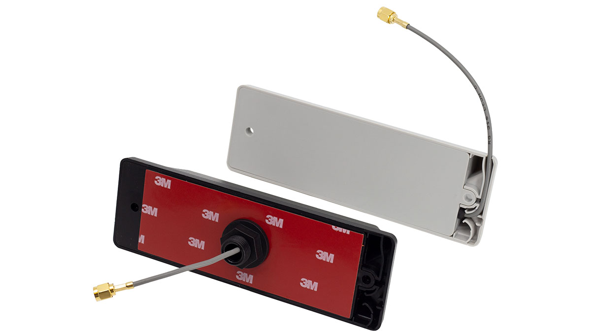 Two antenna mounts with cables, one open, one closed, 3M adhesive tape visible.