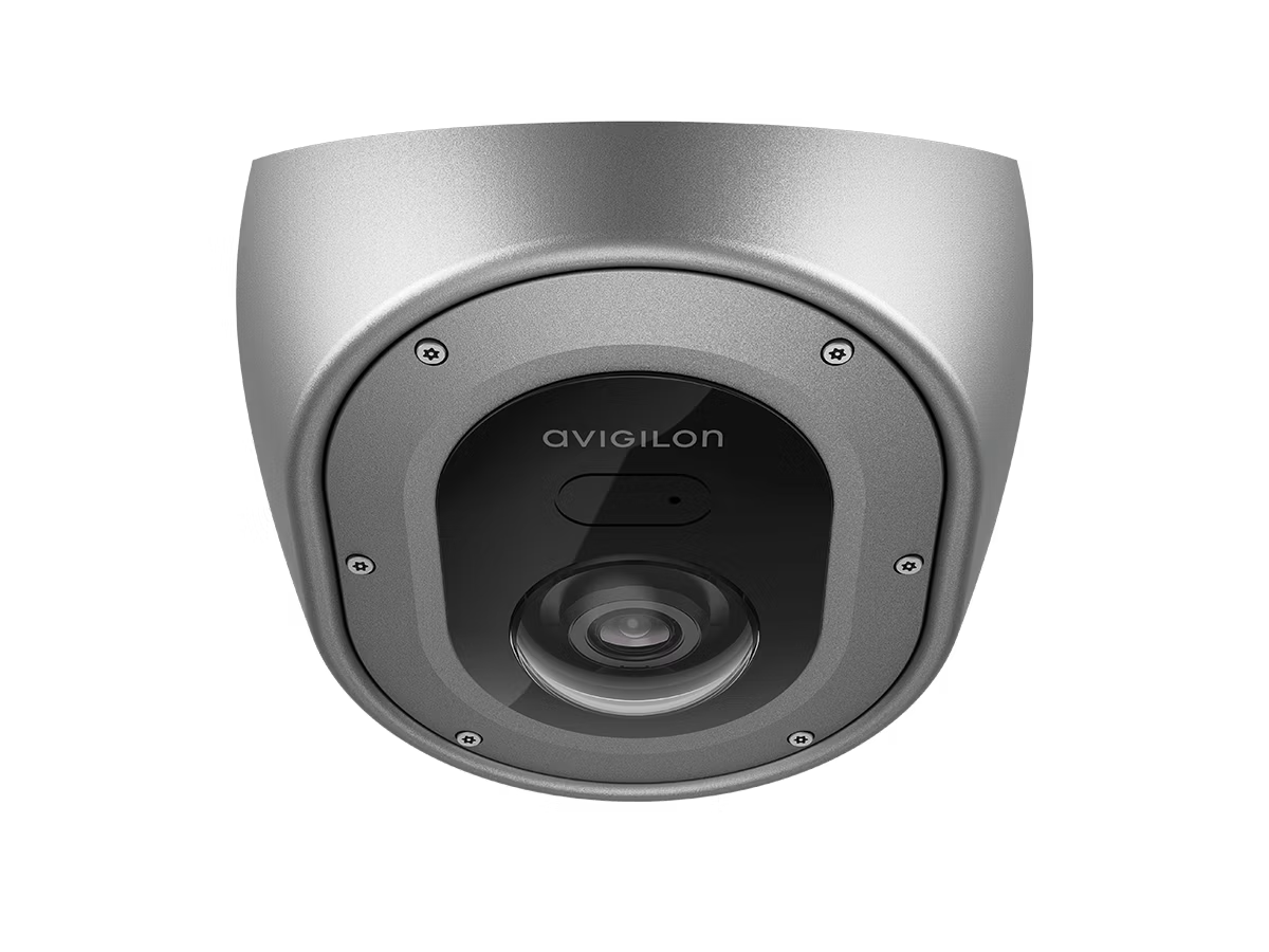 Metallic security camera with lens and rounded casing.
