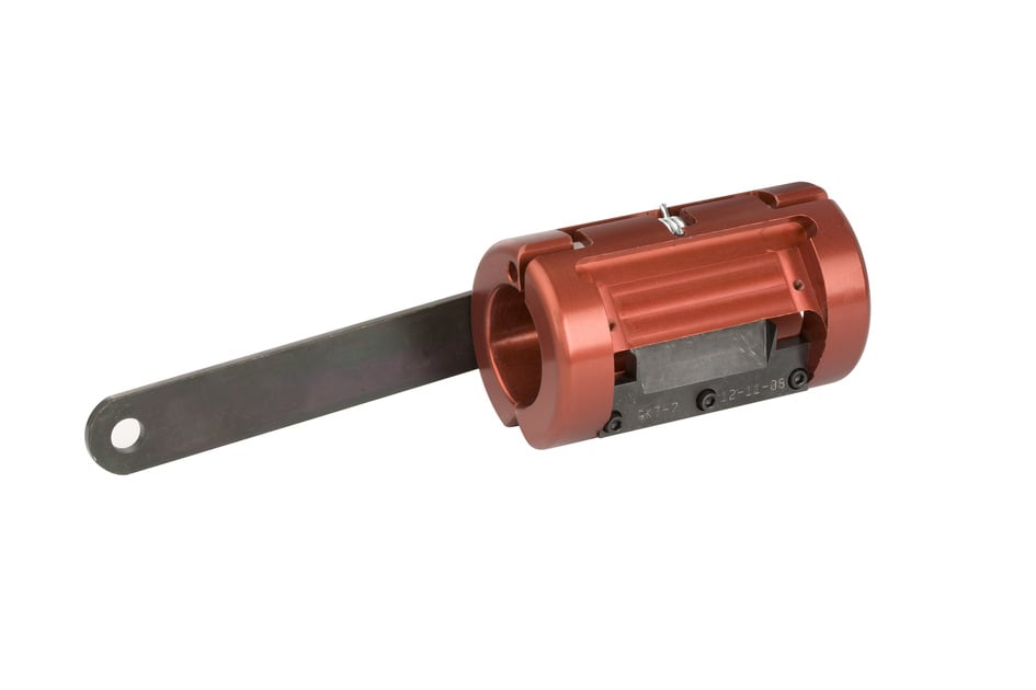 Red metal cylinder with lever arm, technical component.