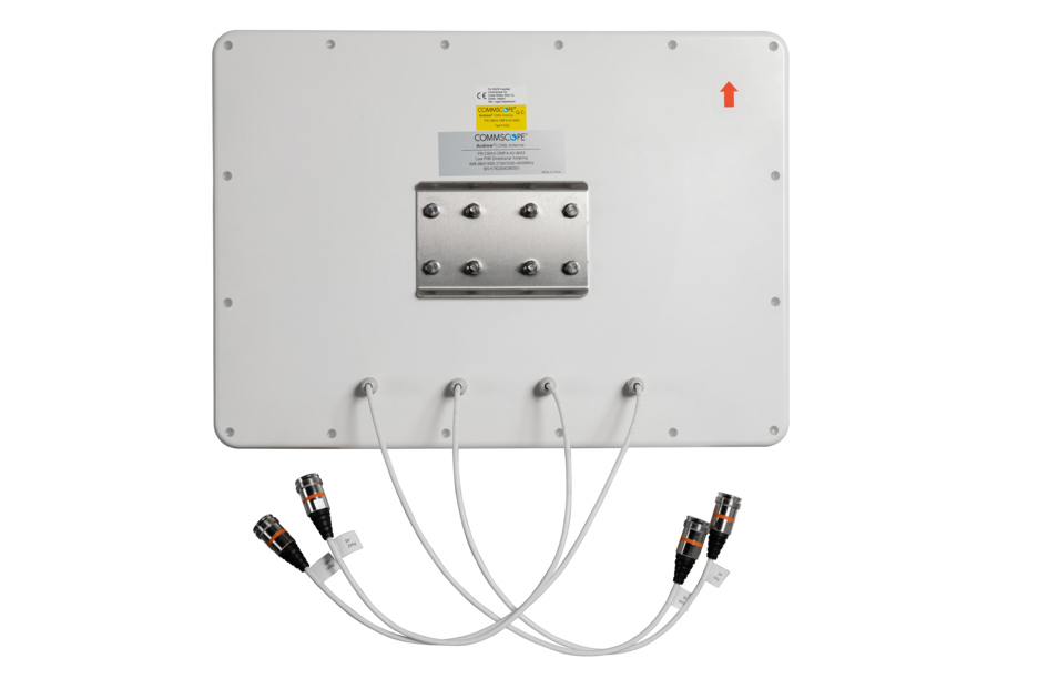 Back view of a white telecommunications antenna with multiple cable connections.