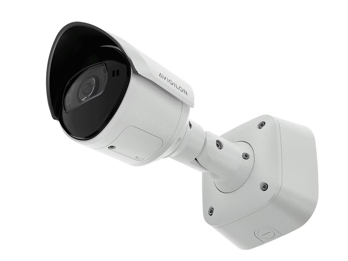 White security camera with wall mount, side view.
