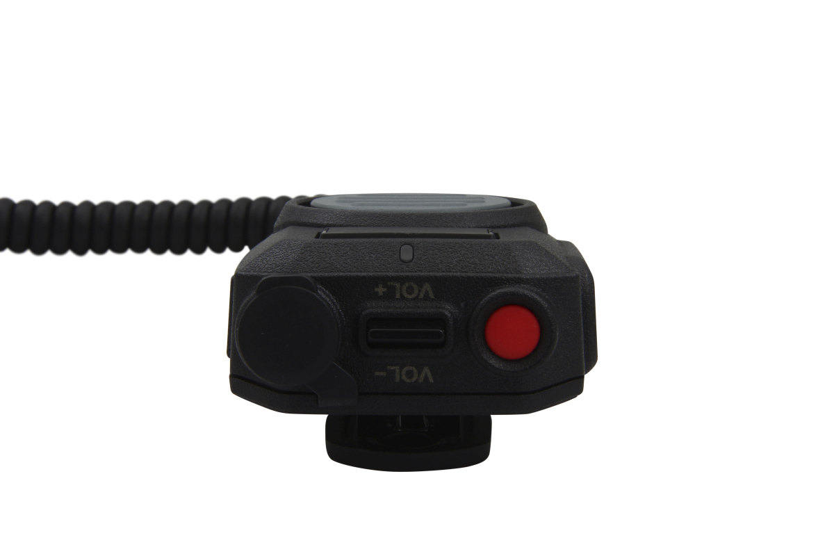 Close-up of a radio device with volume control and red button.