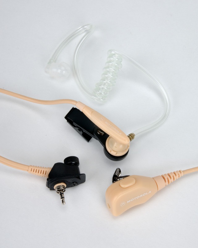 Headset with coiled cable, earpiece, and clip on white background.