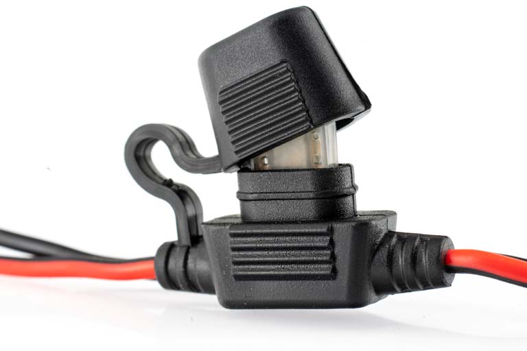 Black fuse holder with red wires and a transparent insert.