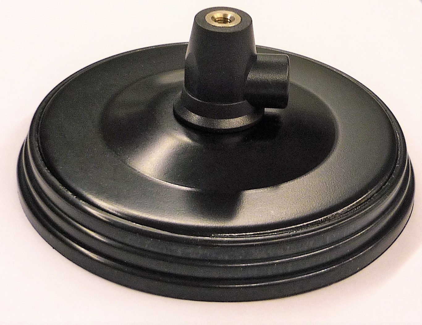 Black round metal base with a bracket on top.